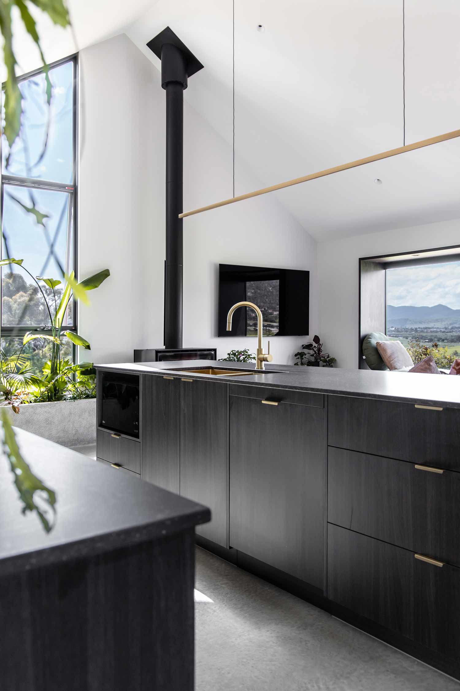 Barndominium-kitchen-with-high-pitched-ceiling-and-brushed-brass