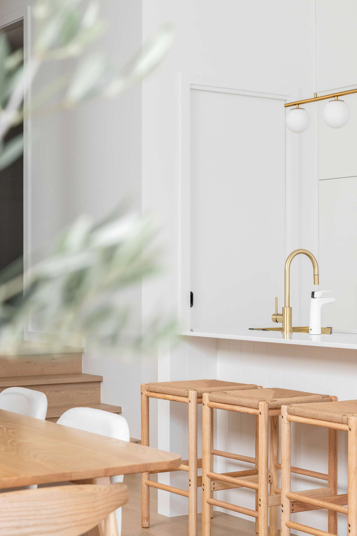 Modern-duplex-house-design-open-plan-kitchen-dining-and-butlers-pantry-with-warm-timber-and-brushed-brass-tapware