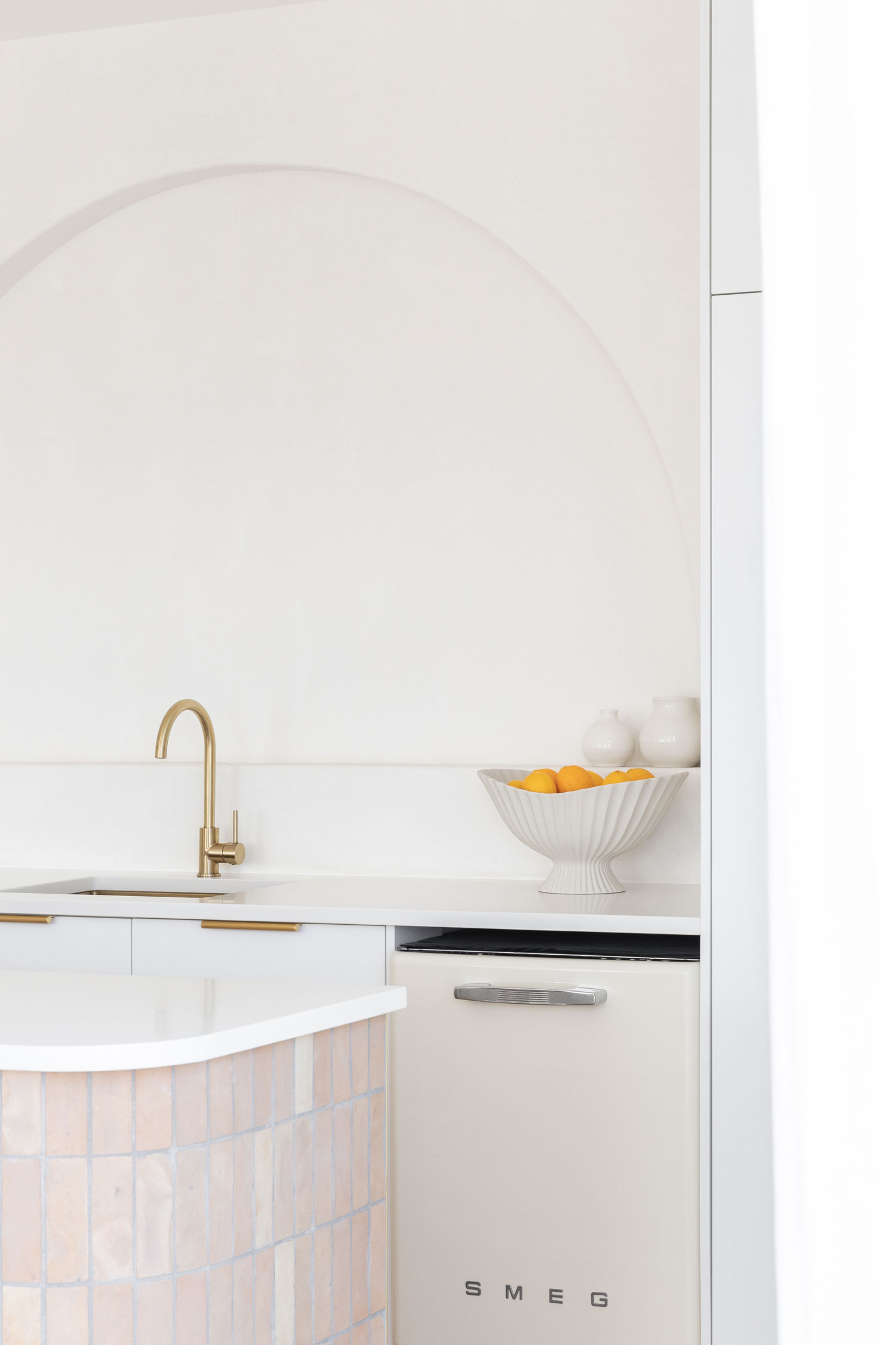 Moditerranean-kitchen-styling-ideas-inclue-brushed-brass-tapware-handmade-clay-tiles-niche-wall-and-a-neutral-colour-palette