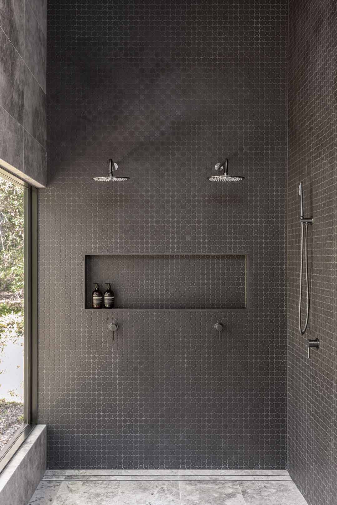 A-symetrical-double-shower-with-large-window-to-the-outdoors-in-this-industrial-style-alpine-lodge