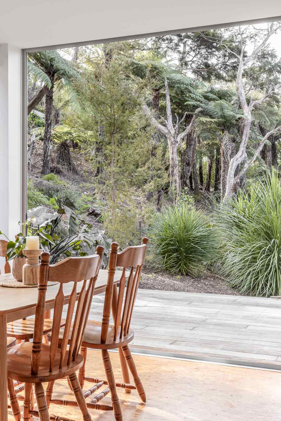 Dining-room-on-the-tiny-home-tour-looks-out-into-nature-and-introduces-different-warm-timbers