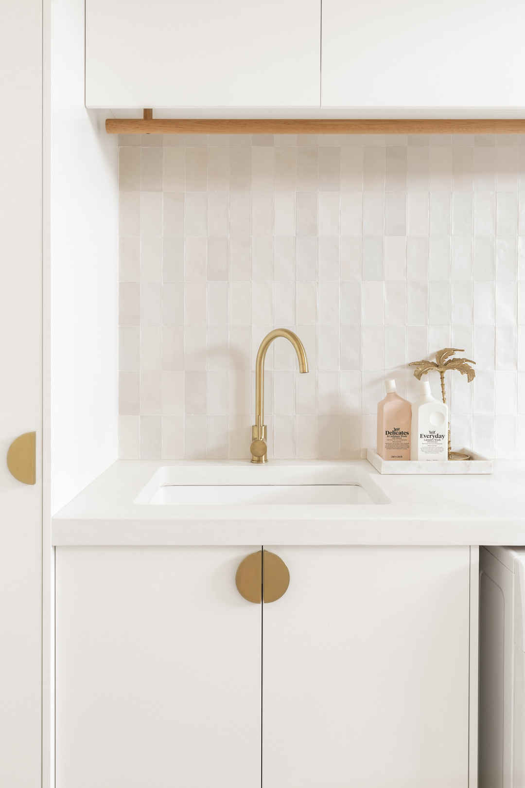Small-laundry-room-ideas-creating-a-clean-space-and-adding-storage-with-a-hanging-drying-rail-and-shelves