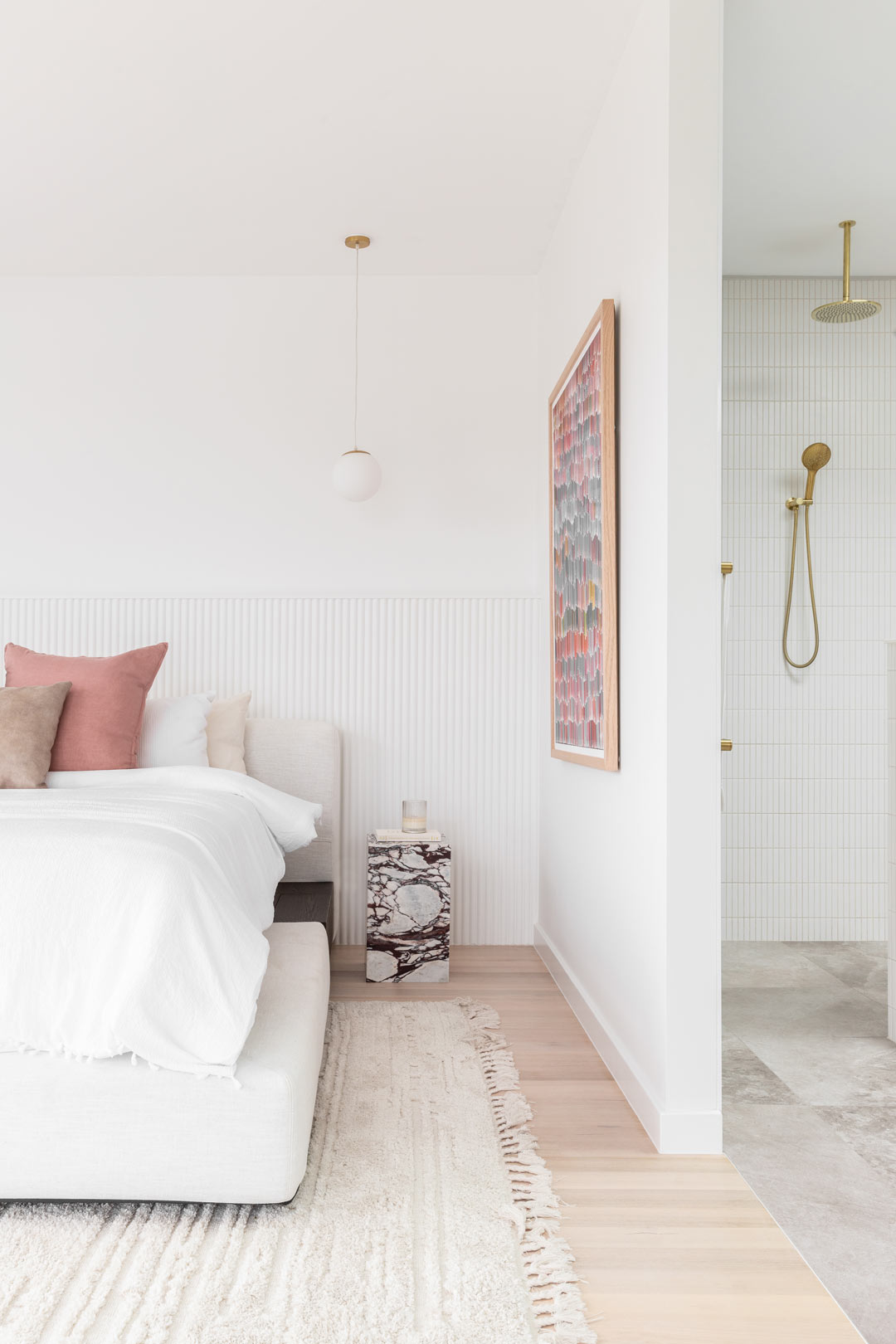 A-luxury-master-bedroom-with-a-muted-pastel-colour-palette-meets-an-open-ensuite-with-brushed-brass-tapware