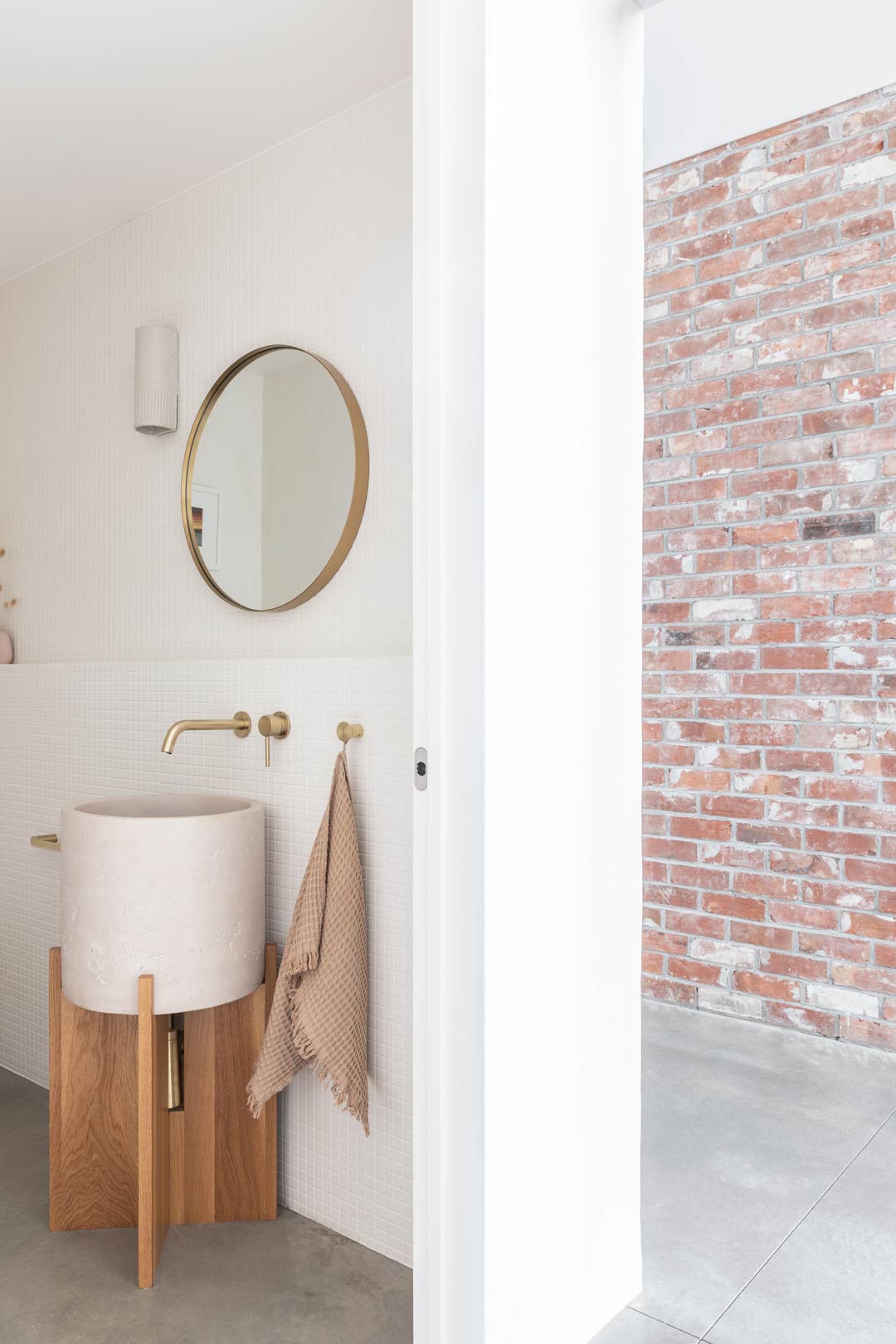 Mediterranean-interior-design-meets-modern-barnhouse-with-exposed-brick-details-a-concrete-basin-and-brushed-brass-tapware