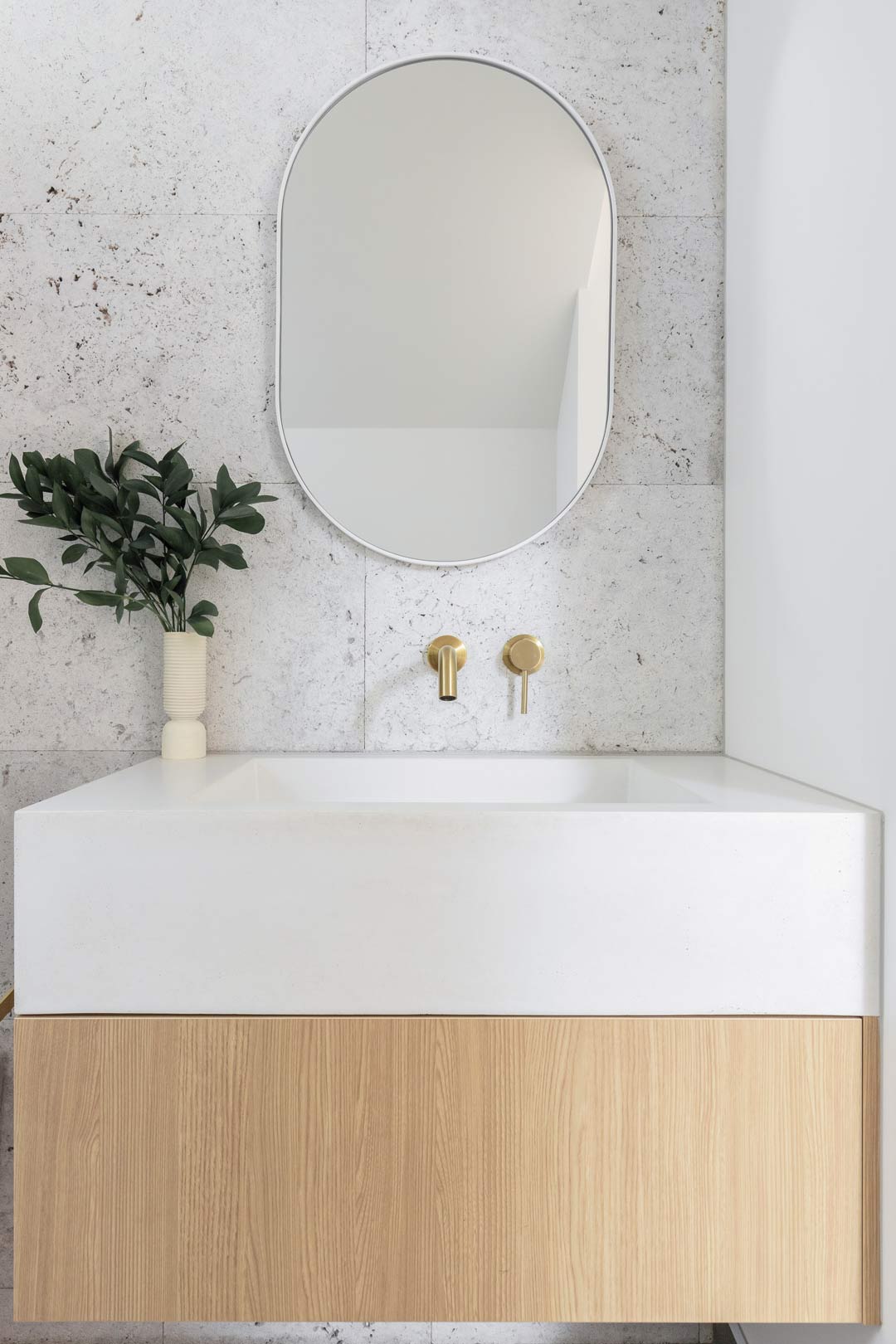 Simple-mediterranean-interior-design-in-this-crisp-bathroom-with-brushed-brass-tapware-and-a-timber-vanity