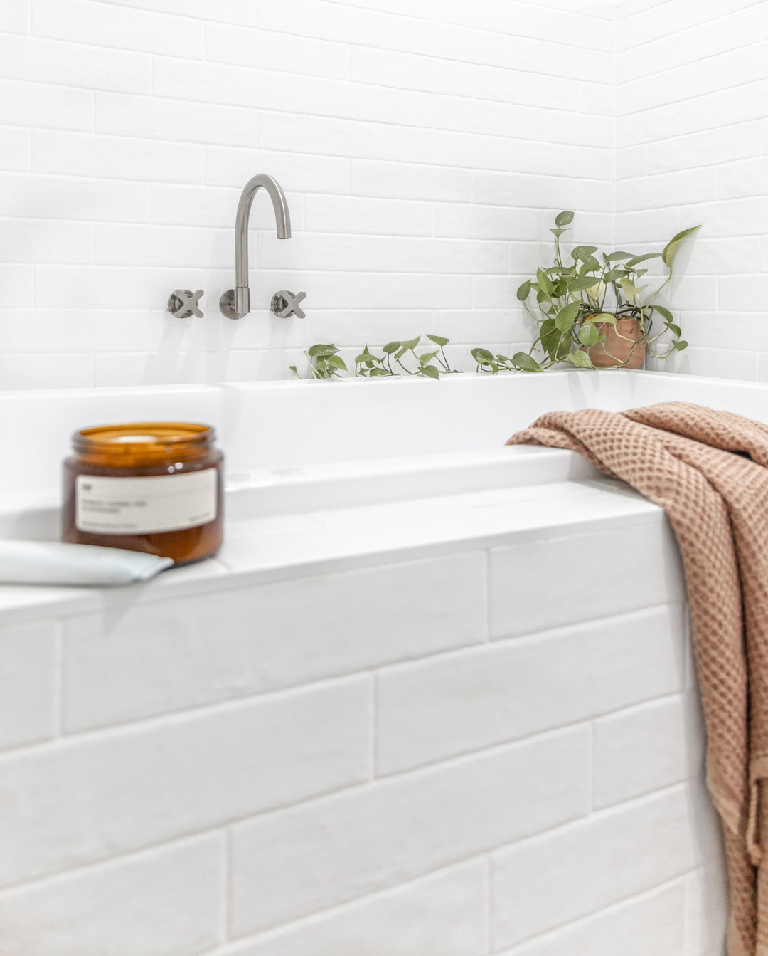 3.-A-simple-built-in-bath-with-cross-taps-a-swivel-bath-shpout-and-subway-tiles