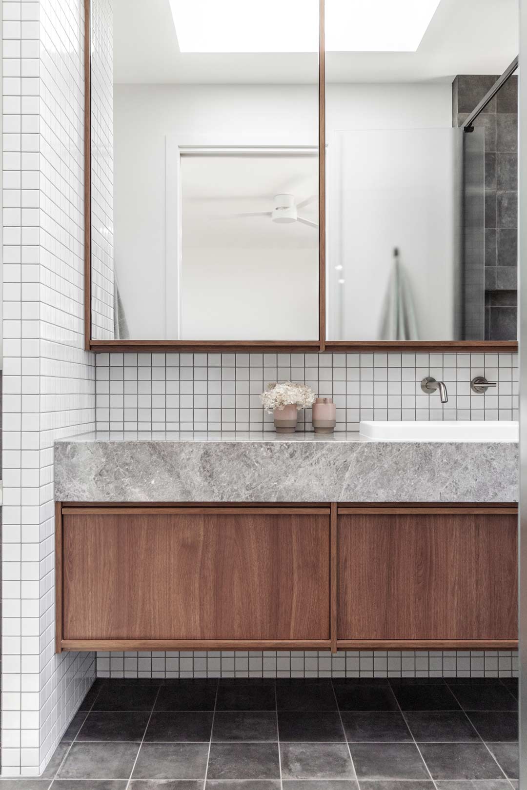 Concrete-bathroom-accessories-in-this-mixed-finish-bathroom-with-mosaic-tiles-walnut-timber-vanity-and-a-concrete-look-stone-bathroom-vanity-top