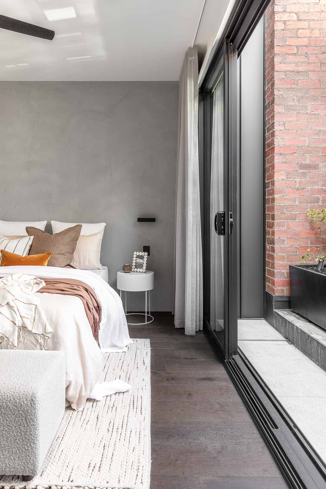 A-master-bedroom-with-sliding-doors-opening-out-to-a-patio-courtyard
